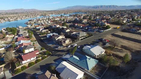 aerial over a suburban neighborhood in the desert with an artificial lake distant 4