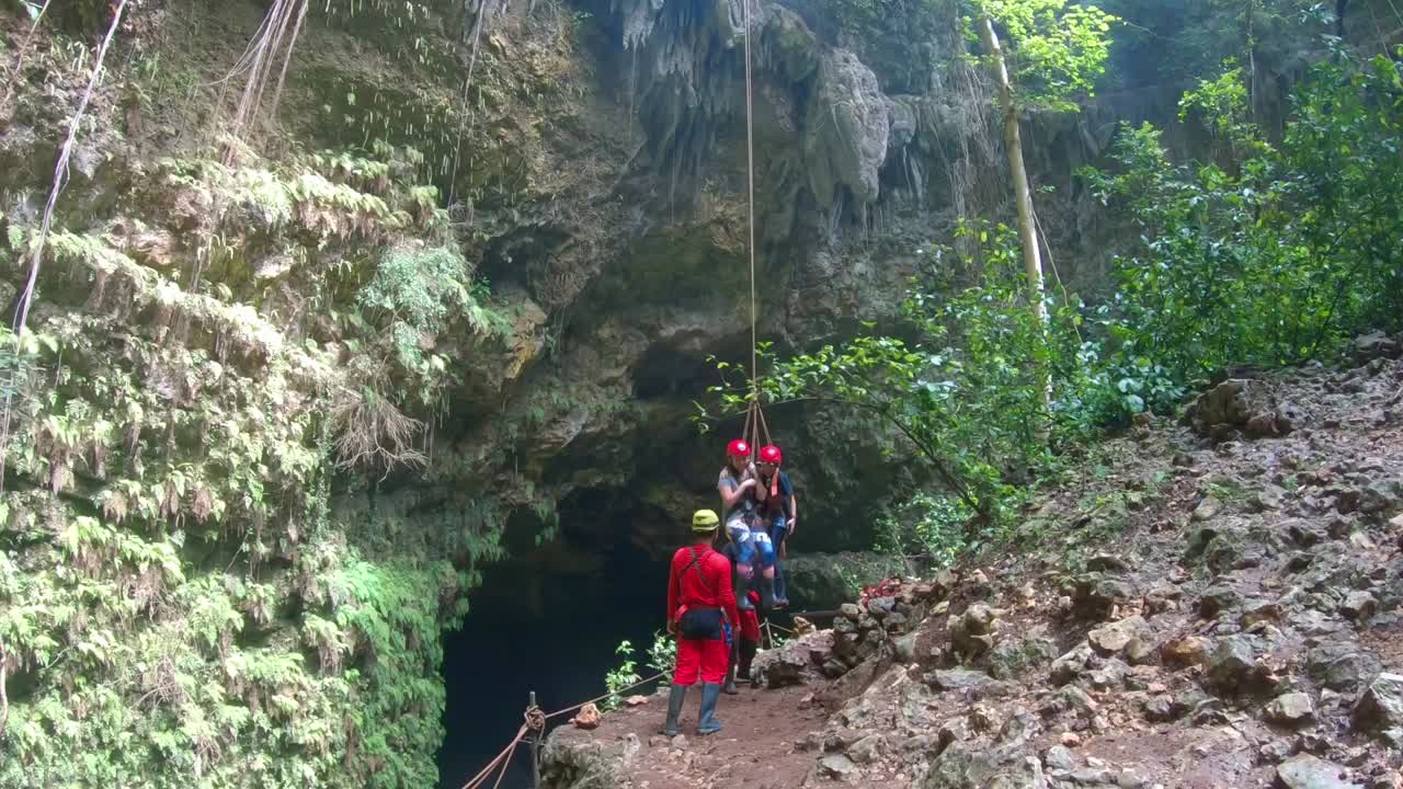 GoPro shot of two people being lowered and descending into the Jomblang cave in Yogyakarta Indonesia
