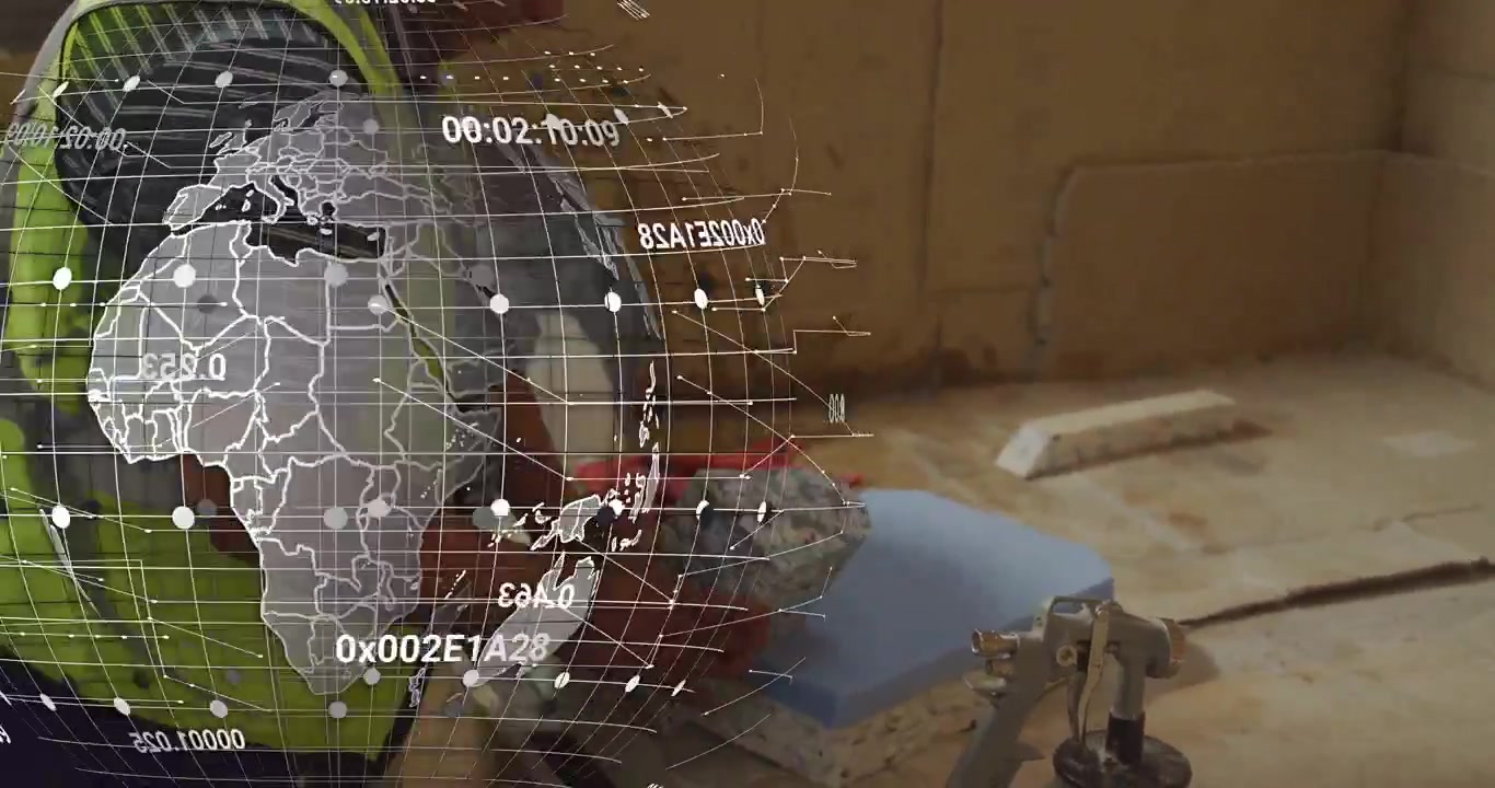 Holographic globe appearing, workshop technician leaning and inspecting red component for repair