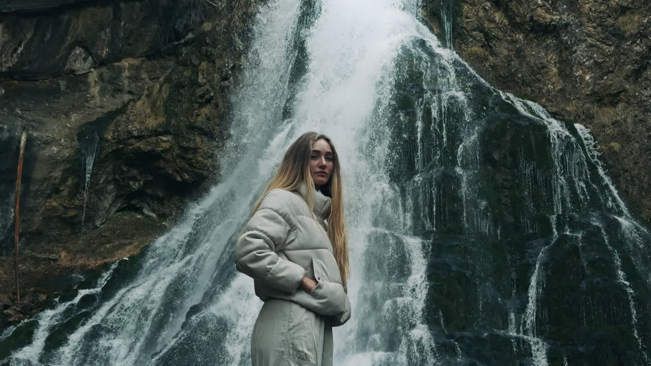 Woman Posing in Front of Waterfall