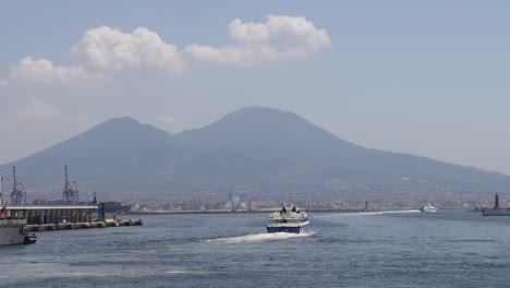 boat moving across water with mountain backdrop