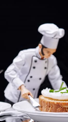 miniature professional chef delicately cutting bread slice, garnishing with fresh cream and chives on pristine white plate against stark black background, capturing intricate culinary artistry