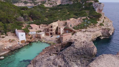 side panning shot of s'almonia cove mallorca clear blue water, aerial