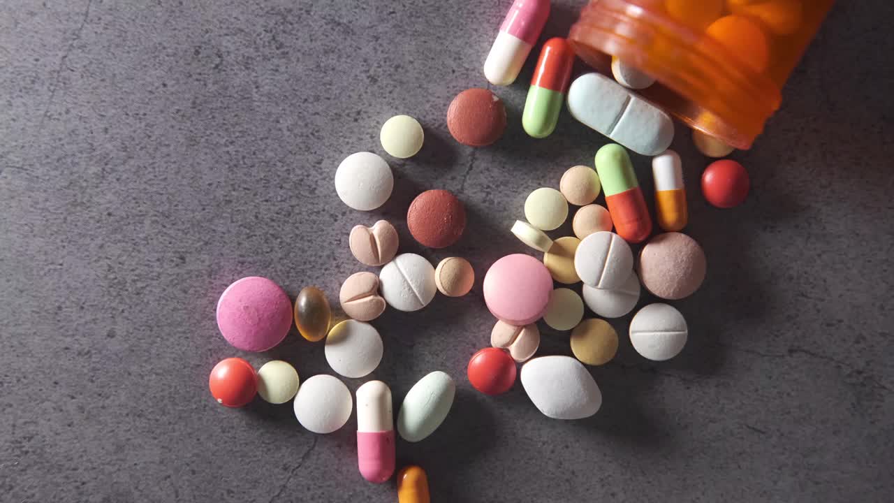 Assorted Pills and Capsules Scattered on a Surface