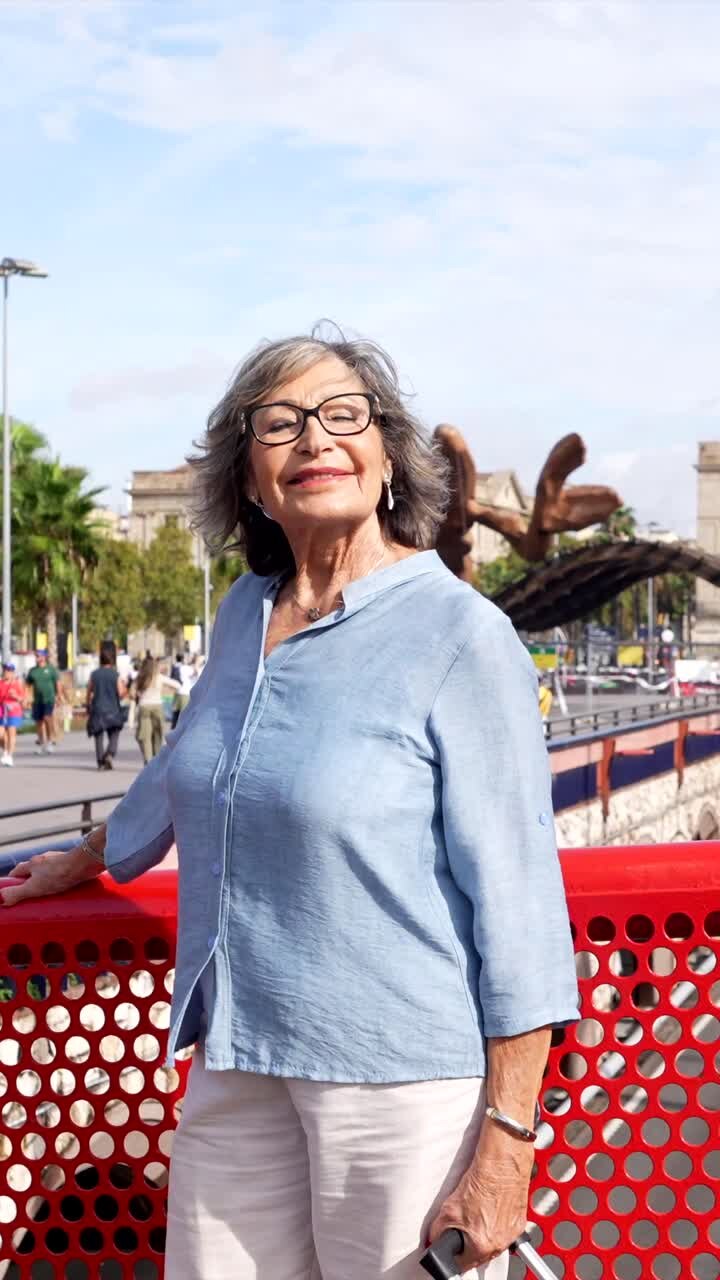 Portrait of an older woman with gray hair in a city setting