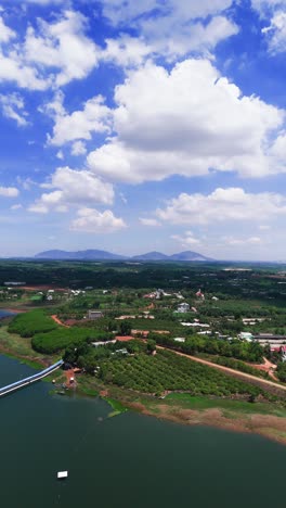 aerial view dolly of the farm and the mountains in dong nai.