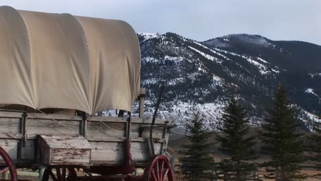 different views of a covered wagon on the prairie