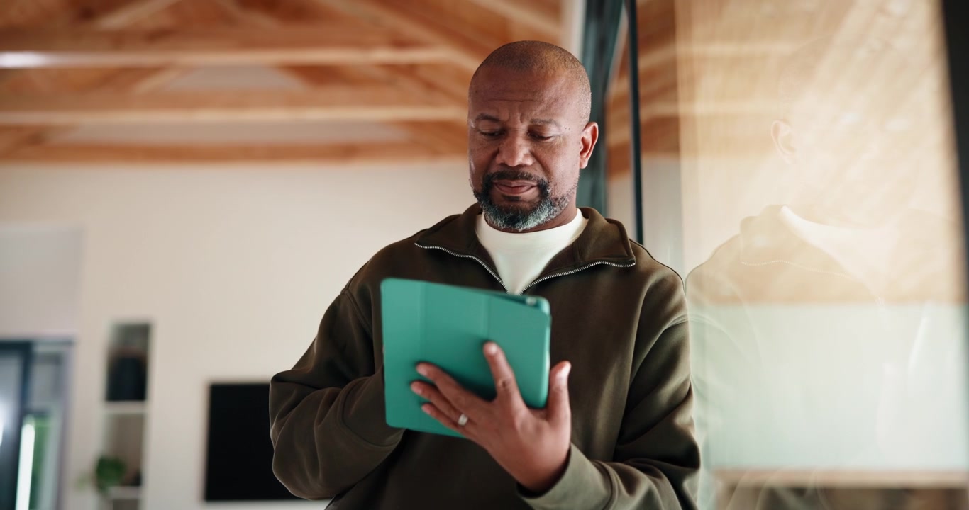 Mature Man Using Digital Tablet in Modern Home Interior