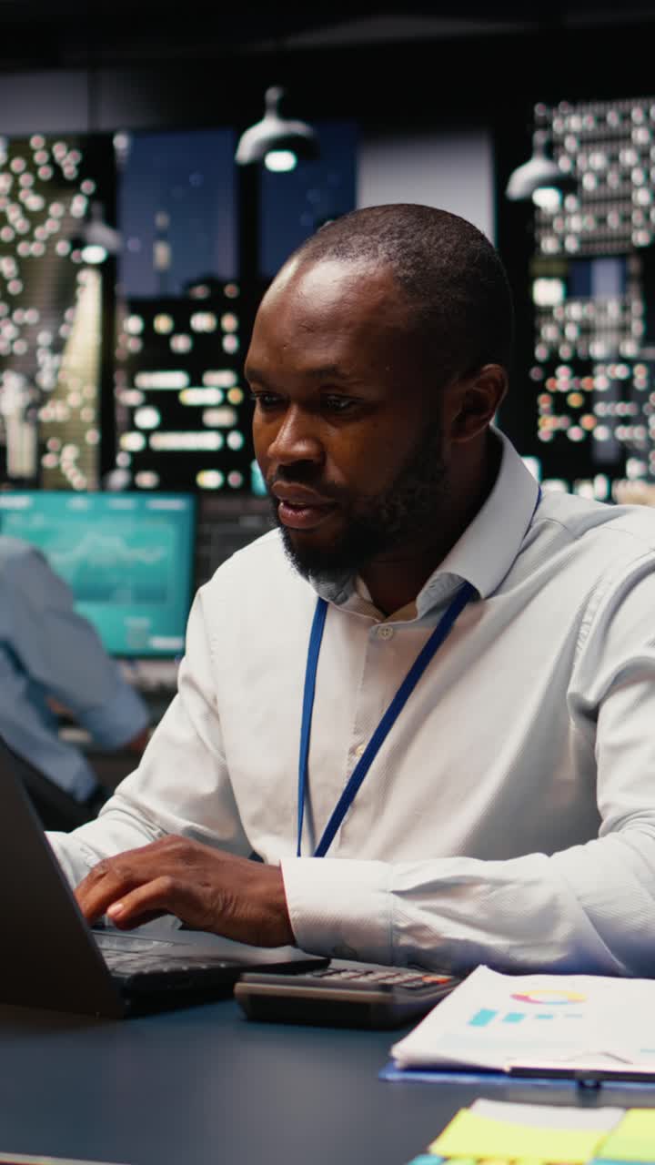 Vertical Video African american manager analyzes company data for accounting task