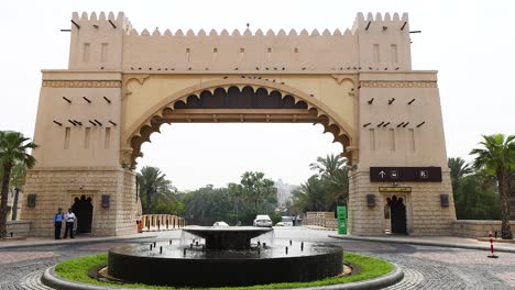 people walking near gate and fountain