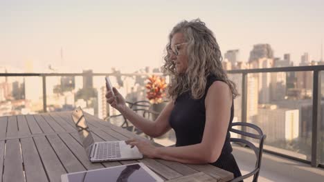 young-elderly-woman-using-technologies-outside