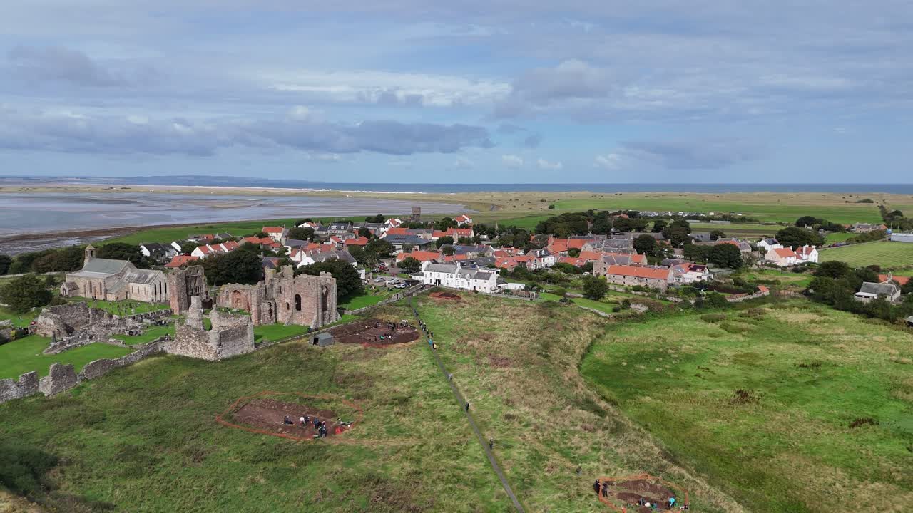 Lindisfarne priory holy island England Panning drone aerial