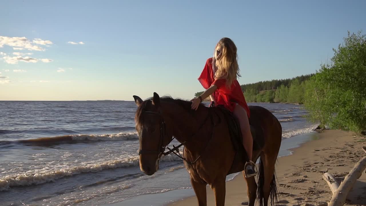 Woman Horseback Riding on Beach at Sunset