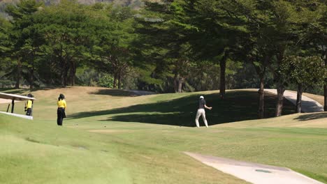 golfer swinging and hitting the ball on course