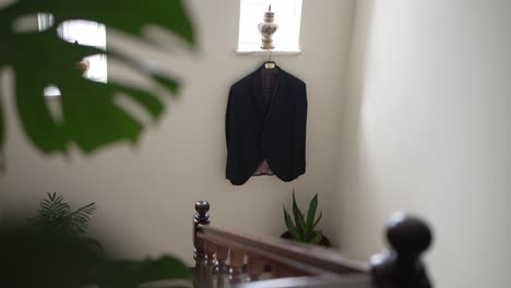 stylish jacket hanging on staircase wall