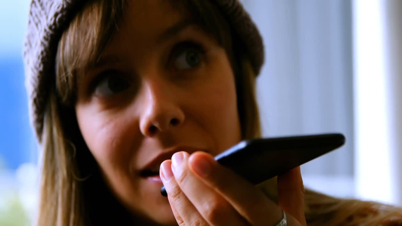 Woman talking on mobile phone at home 4k