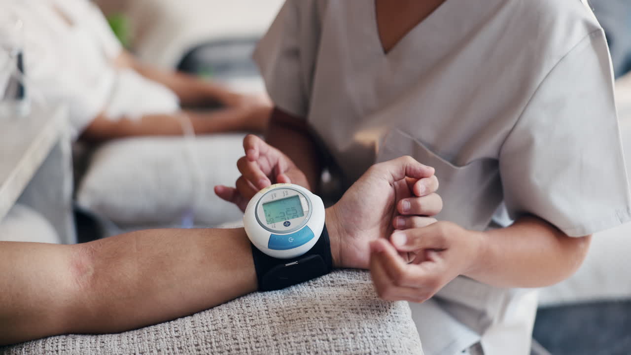 Medical Professional Attaching Blood Pressure Monitor to Patient's Wrist