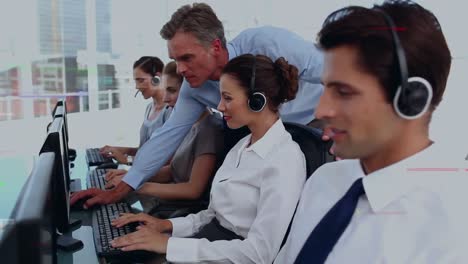 Animation-of-data-processing-over-business-people-using-phone-headsets