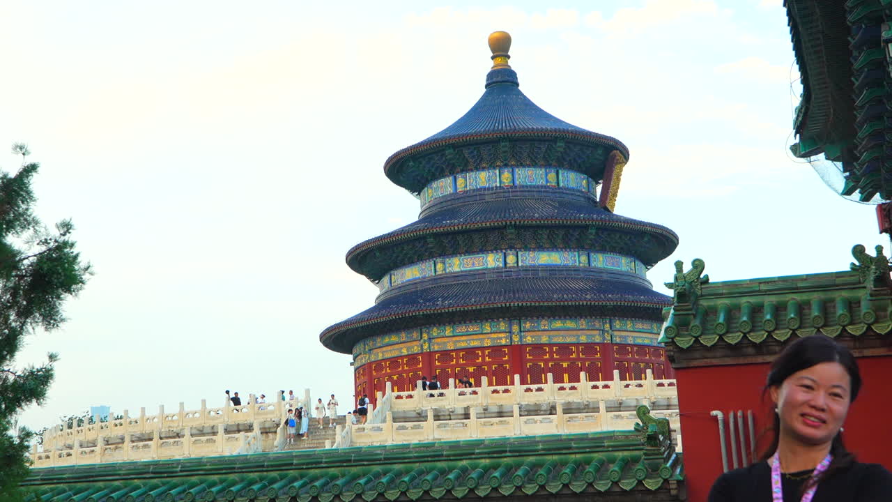 Chinese female tourist smiling in temple of heaven, Beijing. Slow motion