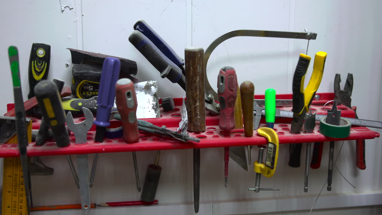 Workbench Tool Shelf With Assorted Hand Tools Lined On Red Organizer, Pliers, Screwdrivers, Hammer, Measuring. Media