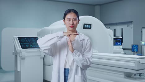 Asian Woman Doctor Doing Time Out Gesture With Hands With Mri Machine In The Hospital