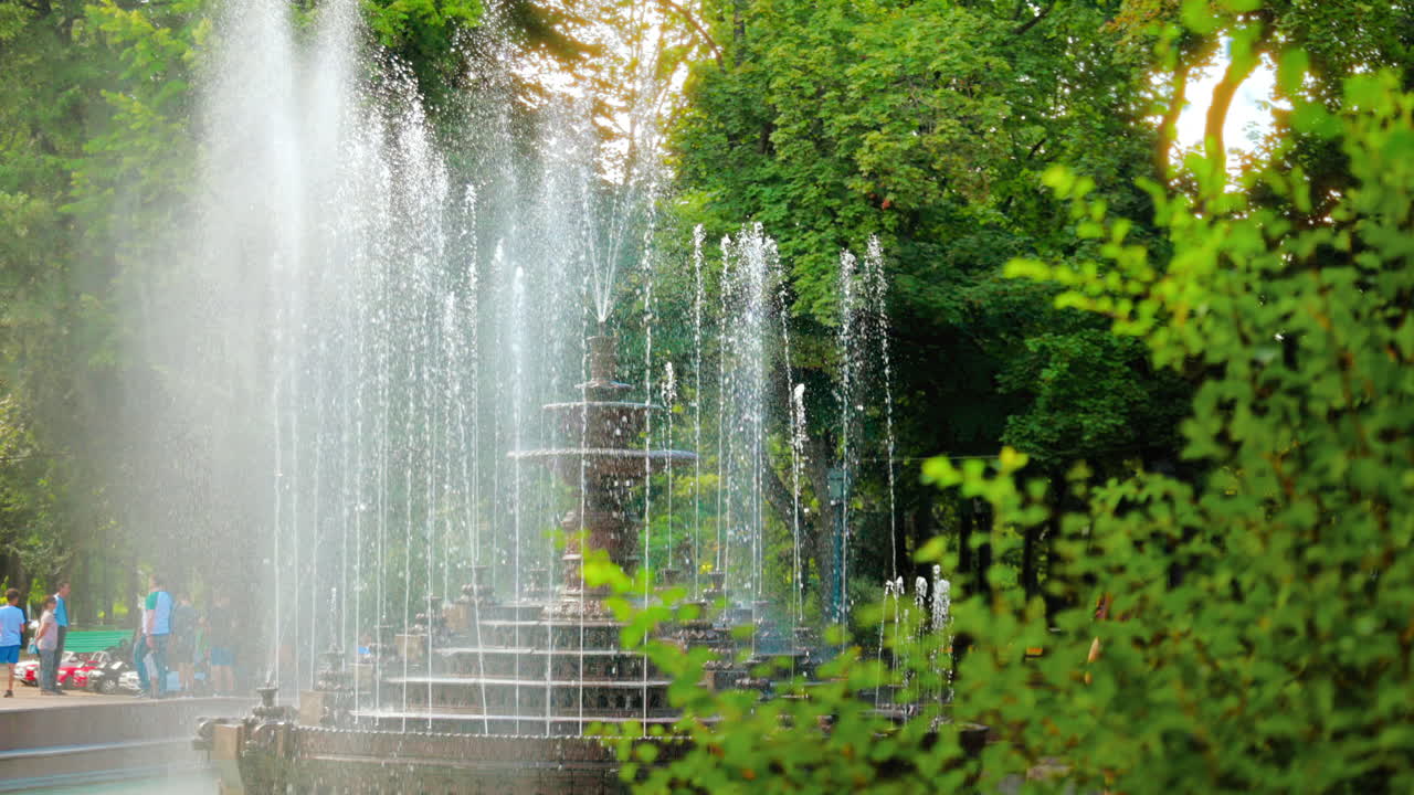 View of the Stefan cel Mare Central Park in Chisinau, Moldova. Working fountain, walking people and greenery