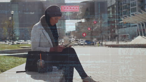 arab woman using tablet in the street