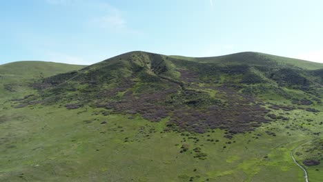 A-drone-pan-over-a-green-mountain