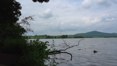 A-beautiful-lake-in-the-wilderness-with-a-sky-full-of-puffy-clouds