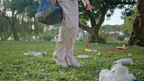 volunteer walking park trash pollution. conservationist girl stepping grass