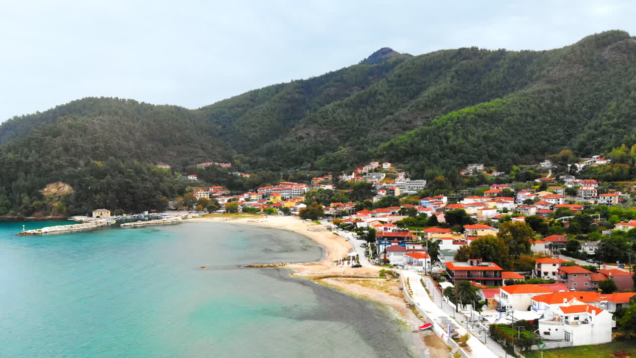 Aerial view of Aegean sea coast of Thassos, buildings, beach, hills on the background, Greece