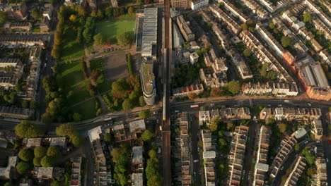 aerial shot of london overground train stopping at kentish town west station