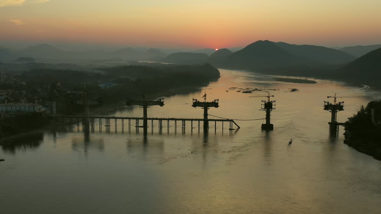 Bridge Construction Under Sunset on a River