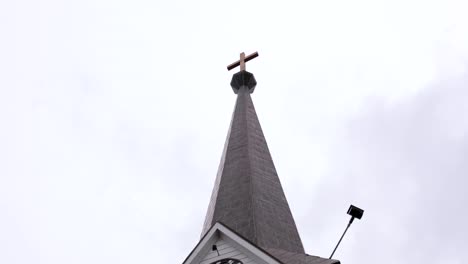 beautiful church with overcast clouds with clock on the front