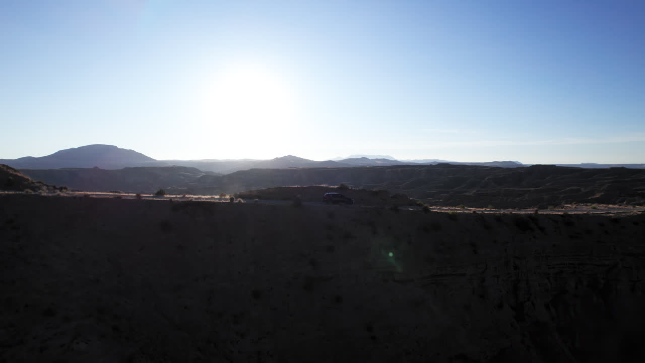 SUV driving on a ridge in the Gorafe desert, Granada, Andalusia, Spain