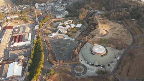 Shigaraki-Ceramic-Cultural-Park-Aerial-Tilt-at-Sunset,-Shiga-Prefecture-Japan