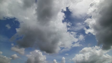 blue sky with fluffy white and gray clouds