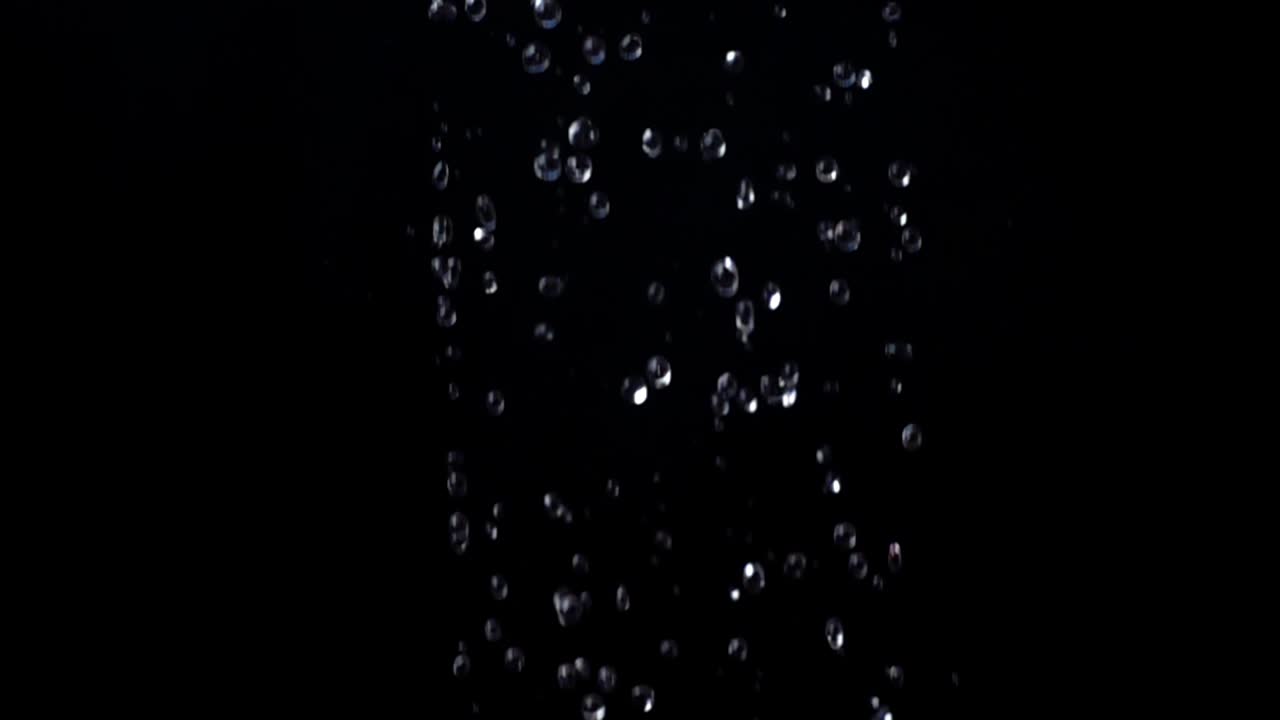 Water on a black background. Slow motion