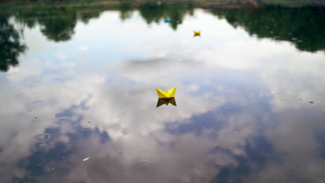 paper boat is floating on the water. origami boat floats away into the distance along the river