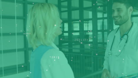 Male doctor holding blue tablet consulting female patient medical corridor, displaying data nodes