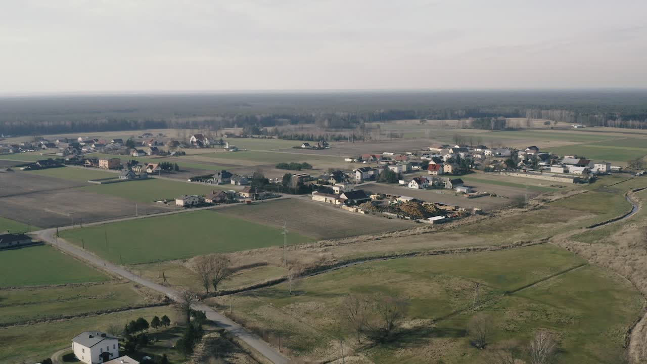 Aerial wide angle drone shot of a small beautiful village in Solarnia, Poland on a bright sunny day
