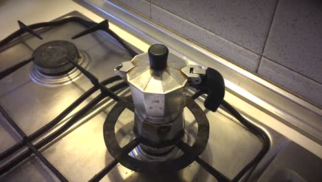 lighting gas stove under moka pot for coffee