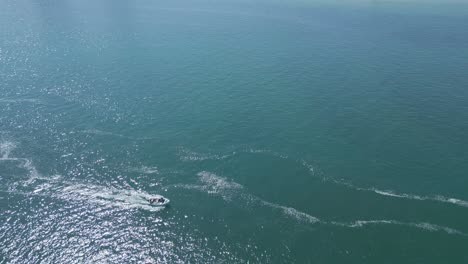 Overview-drone-shot-of-small-boat-in-Sado-river-with-left-to-right-movement