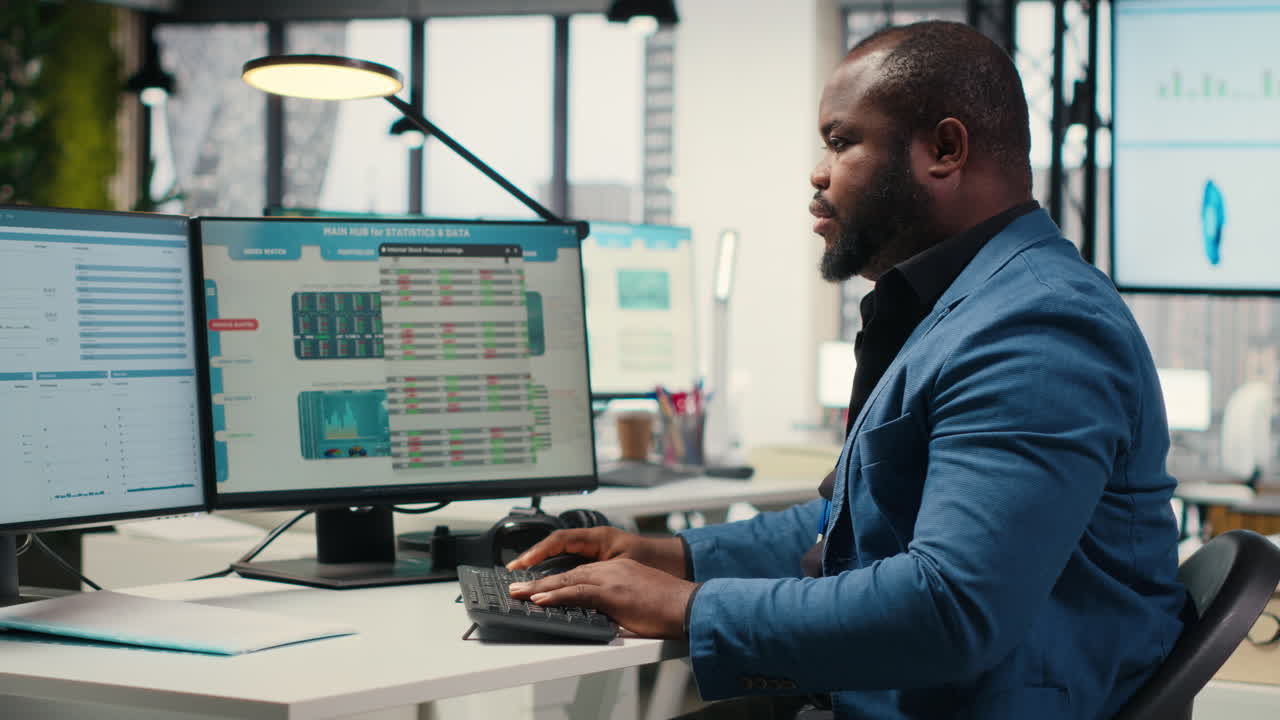 Vertical Video Black male analyst focused on IT company development with digital tools