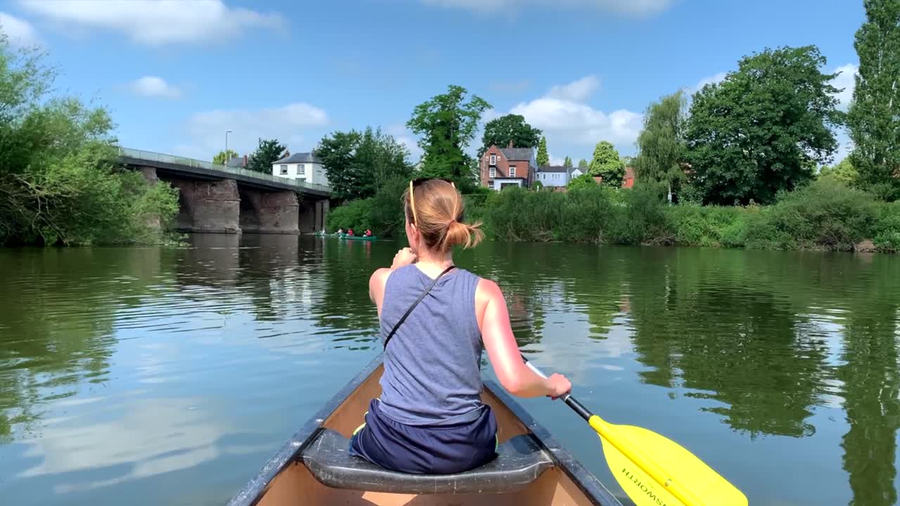 Girl paddling canoe on river wye on sunny day with blue skies Premium ...