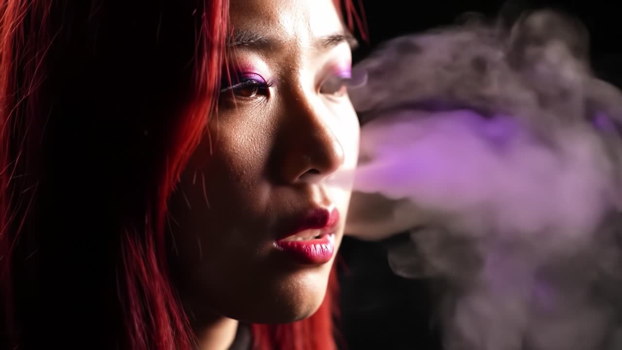 A Young Woman with Vibrant Red Hair Exhales a Cloud of Colorful Smoke Against a Dark Background, Capturing a Moment of Serenity and Intrigue