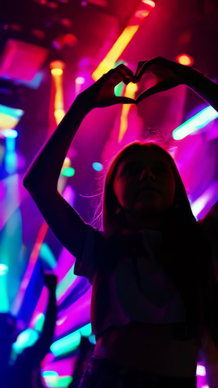 Girl Making Heart Shape at Night Club