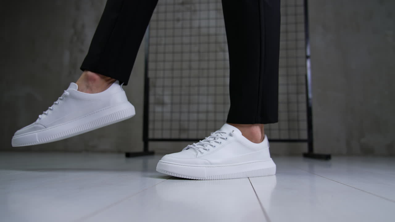 White Leather Sneakers on a Man's Feet