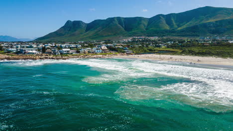 waves crash on white sand beach of scenic holiday town onrus