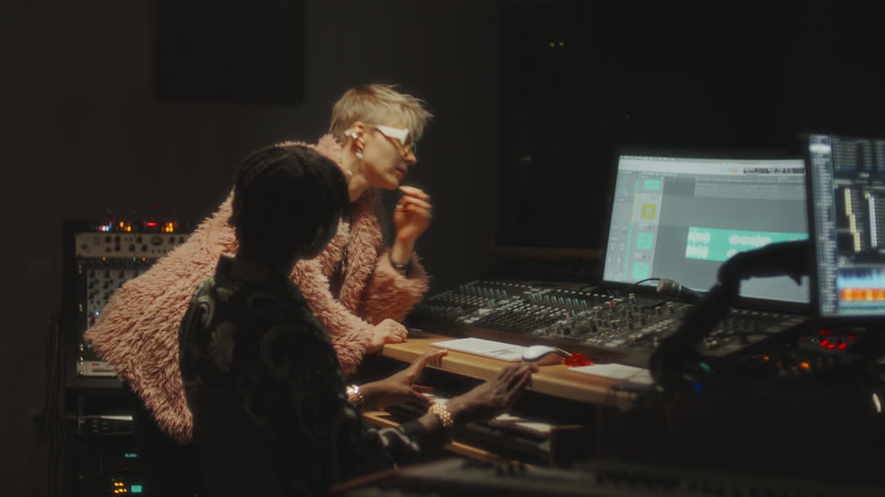 Female Singer and Sound Engineer Having Discussion in Recording Studio